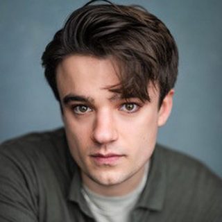 This is a headshot of Adam Wadsworth looking directly to camera.