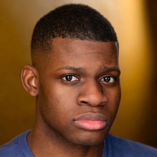 This is a headshot of David Olaniregun looking directly to camera.