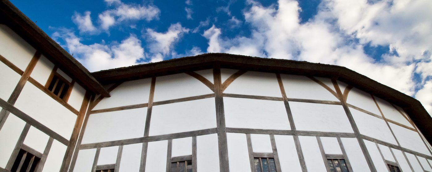 A timber-framed building in front of a blue sky