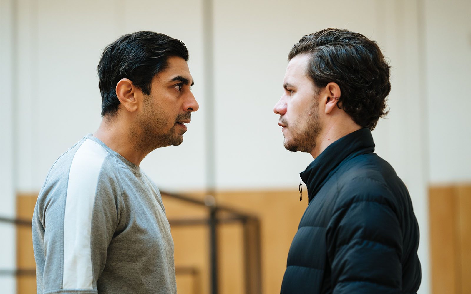 Dharmesh Patel and Oliver Johnstone stand facing each other.