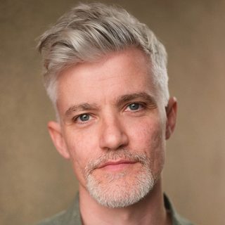 This is a headshot of James Groom looking directly to camera.