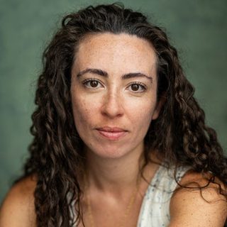 This is a headshot of Jasmin Hinds looking directly to camera.