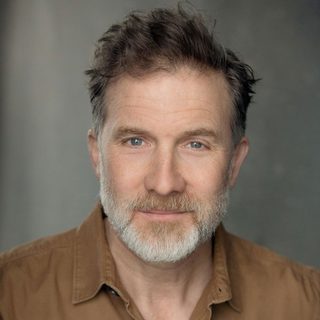 This is a headshot of Jo Stone-Fewings looking directly to camera.