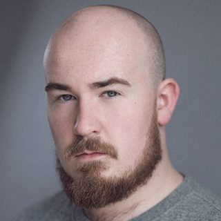 This is a headshot of Joshua Dunn looking directly to camera.