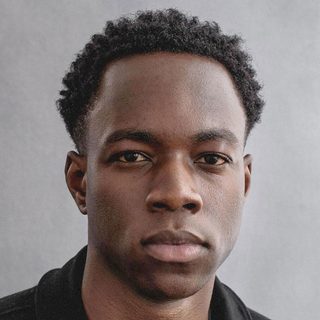 This is a headshot of Kelvin Ade looking directly to camera.