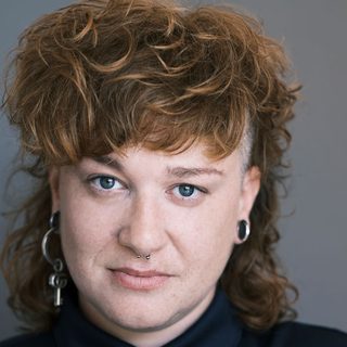 This is a headshot of LJ Parkinson looking directly to camera.