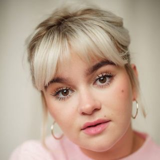 This is a headshot of Lola Shalam looking directly at the camera.