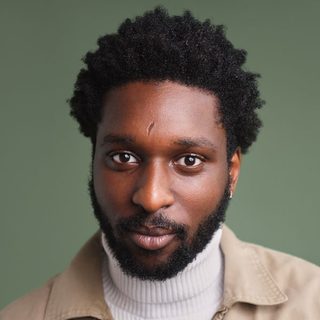 This is a headshot of Marcus Olale looking directly to camera.