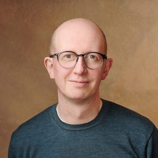 This is a headshot of Piers Torday looking direct to camera.