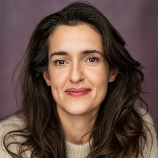 This is a headshot of Phoebe Pryce looking directly to camera.