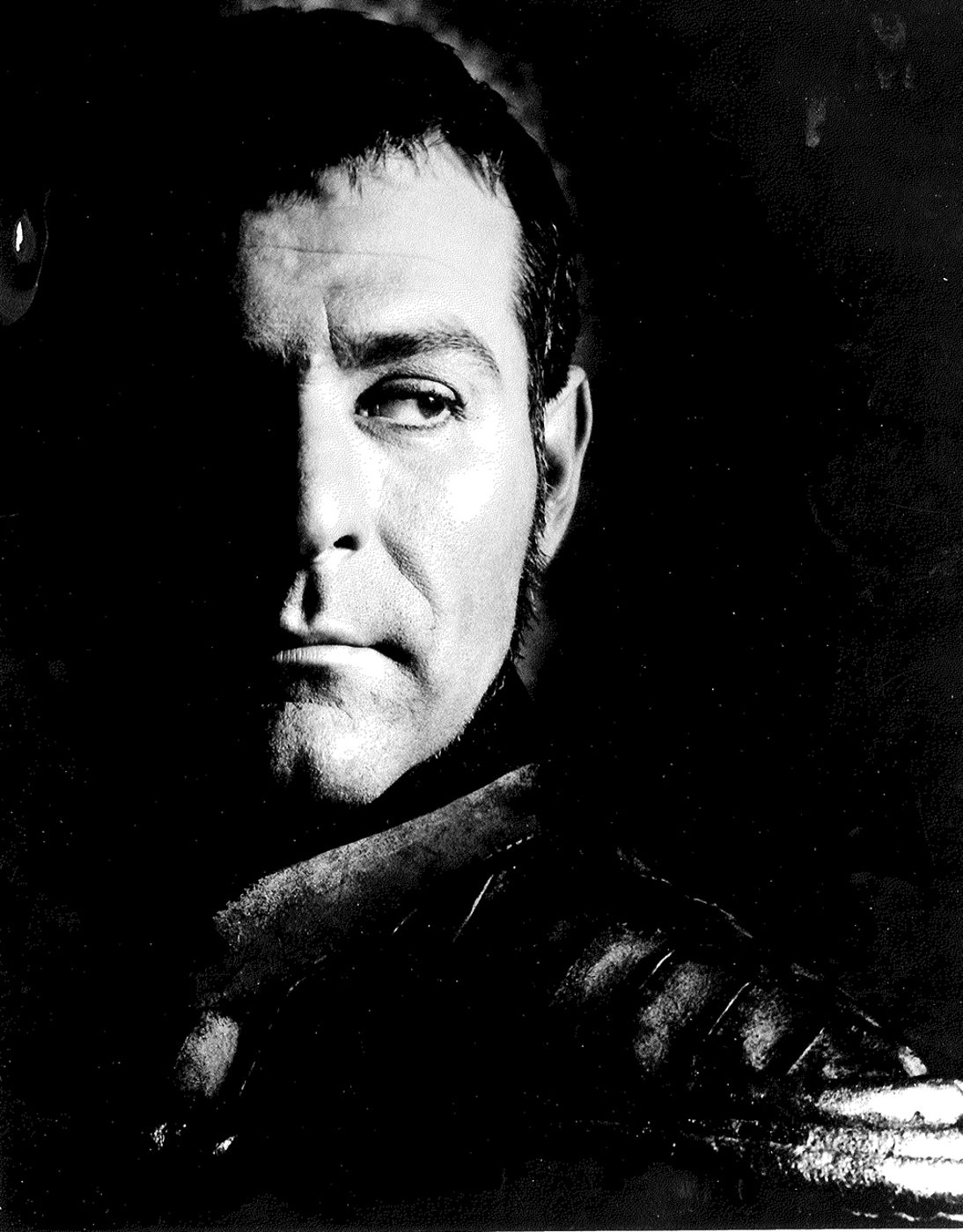 A man stands in the shadows