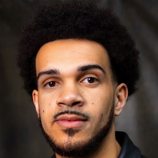 This is a headshot of Simeon Desvinges looking directly to camera.