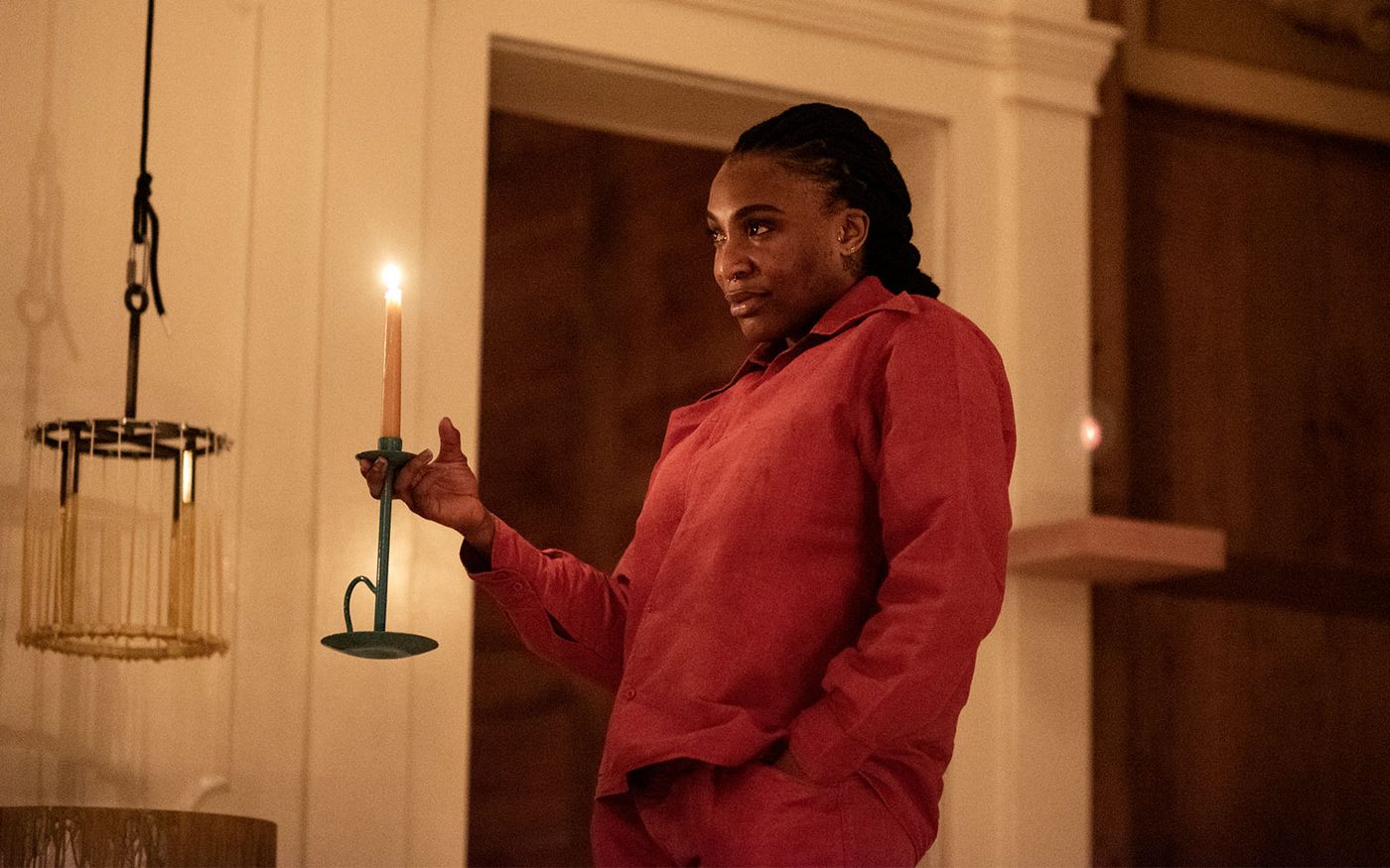 An actor holds a lit candle