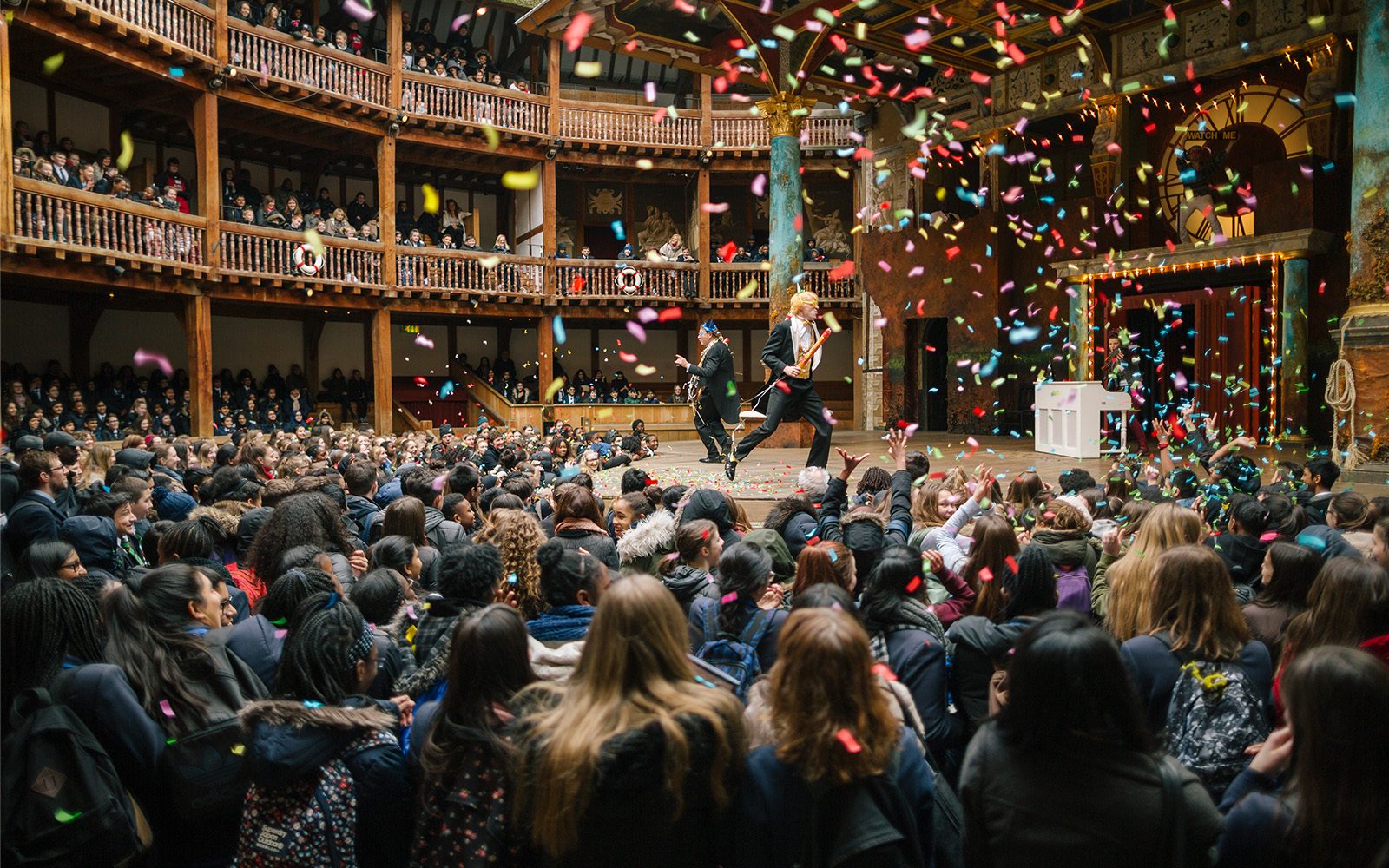 Confetti explode as Sir Andrew and Sir Toby run around the stage