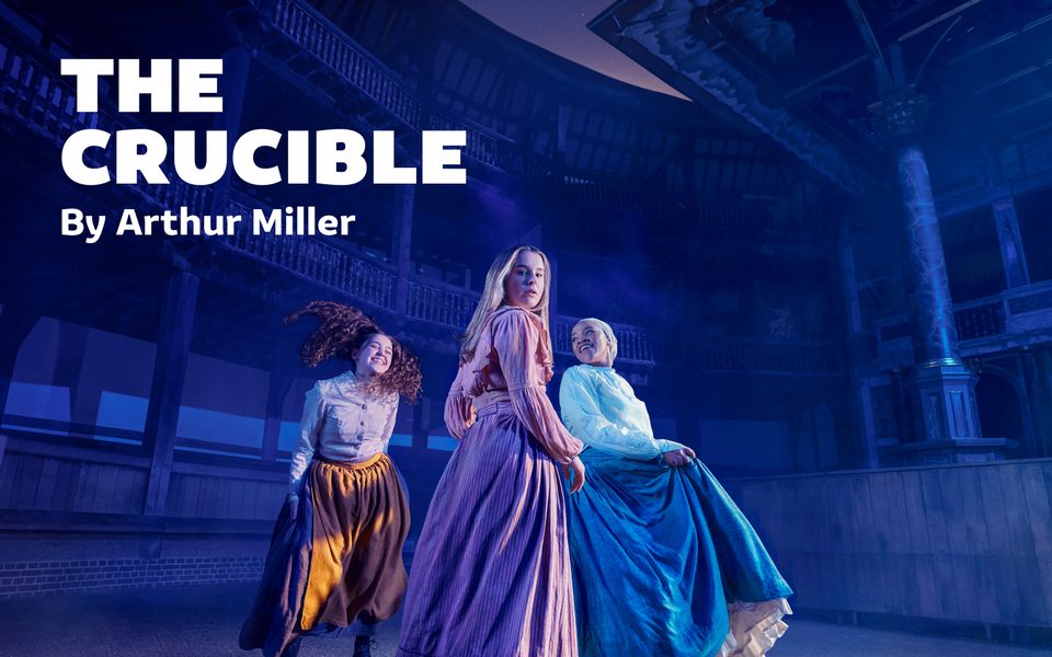Three young women in the Globe. They're wearing period costume contemporary with The Crucible's setting - long skirts and blouses. Two of them are smiling and laughing, but the central woman looks at the camera as if shocked. Text reads "The Crucible by Arthur Miller"