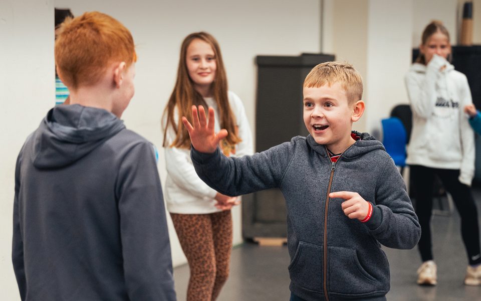 Happy children in a rehearsal room.