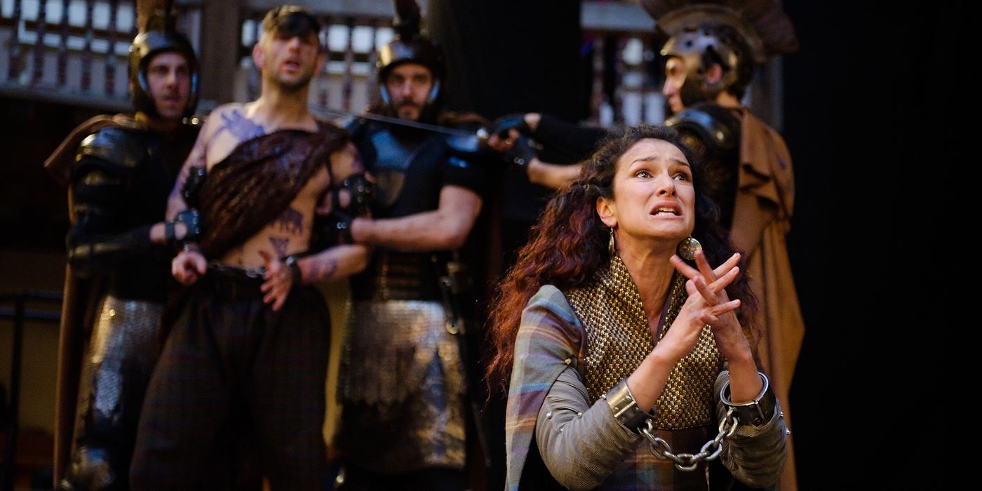 A woman kneels on the floor in desperation, pleading.
