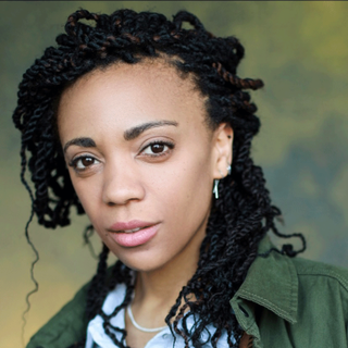 This is a headshot of Janet Etuk looking directly to camera.